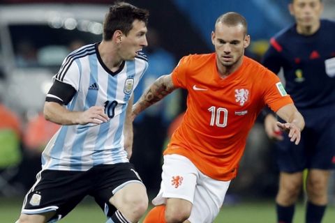 Argentina's Lionel Messi, left, tries to get around Netherlands' Wesley Sneijder, right, during the World Cup semifinal soccer match between the Netherlands and Argentina at the Itaquerao Stadium in Sao Paulo Brazil, Wednesday, July 9, 2014. (AP Photo/Victor R. Caivano)