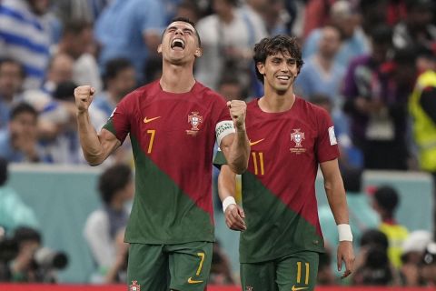 Portugal's Cristiano Ronaldo, second left, celebrates , in front of his teammate Joao Felix the opening goal of his team against Uruguay during the World Cup group H soccer match between Portugal and Uruguay, at the Lusail Stadium in Lusail, Qatar, Monday, Nov. 28, 2022. (AP Photo/Martin Meissner)