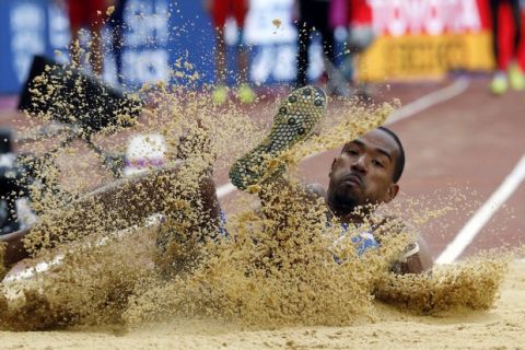 United States' Christian Taylor makes his attempt in the men's triple jump qualification during the World Athletics Championships in London Monday, Aug. 7, 2017. (AP Photo/Matthias Schrader)