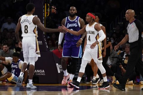 New Orleans Pelicans forward Naji Marshall (8) and guard Devonte' Graham (4) high-five after a foul call during the first half of an NBA basketball game against the Los Angeles Lakers in Los Angeles, Friday, April 1, 2022. (AP Photo/Ashley Landis)