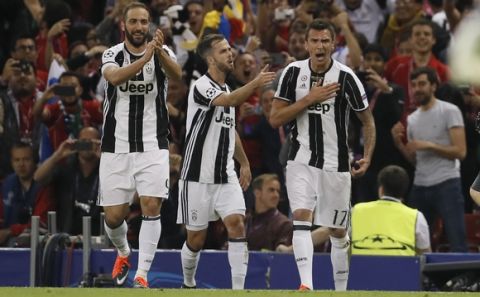 Juventus' Mario Mandzukic, right, celebrates with teammates Juventus' Miralem Pjanic, center, and Gonzalo Higuain, after scoring scores during the Champions League final soccer match between Juventus and Real Madrid at the Millennium Stadium in Cardiff, Wales, Saturday June 3, 2017. (AP Photo/Kirsty Wigglesworth)
