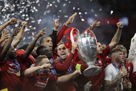 Liverpool's Jordan Henderson lifts the trophy as celebrates with his teammates after winning the Champions League final soccer match between Tottenham Hotspur and Liverpool at the Wanda Metropolitano Stadium in Madrid, Sunday, June 2, 2019. Liverpool won 2-0. (AP Photo/Felipe Dana)