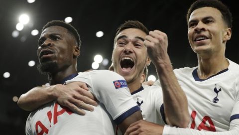 Tottenham's Serge Aurier, left, celebrates his goal with teammates Harry Winks, center, and Dele Ali during the Champions League Group B soccer match between Tottenham Hotspur and Olympiakos at the Tottenham Hotspur Stadium in London, Tuesday, Nov. 26, 2019. (AP Photo/Matt Dunham)