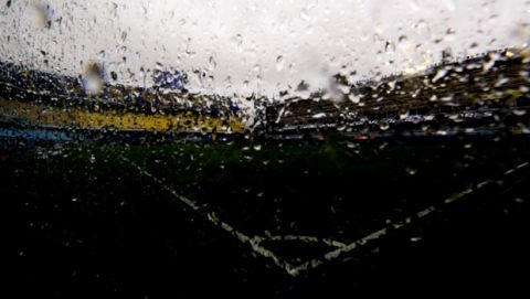 The pitch of the Alberto Armando stadium is seen through a wet glass in Buenos Aires, Argentina Saturday, Nov. 10, 2018. The first leg of the Copa Libertadores final between Boca Juniors and River Plate was postponed because torrential rain flooded the stadium. (AP Photo/Natacha Pisarenko)