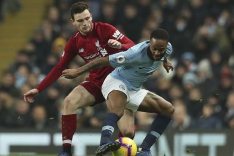 Liverpool's Andrew Robertson, left, vies for the ball with Manchester City's Raheem Sterling during their English Premier League soccer match between Manchester City and Liverpool at the Ethiad stadium, Manchester England, Thursday, Jan. 3, 2019. (AP Photo/Jon Super)