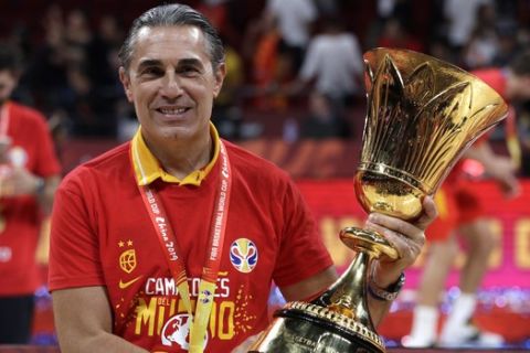 Head coach Sergio Scariolo of Spain holds the Naismith Trophy after they beat Argentina in their first-place match in the FIBA Basketball World Cup at the Cadillac Arena in Beijing, Sunday, Sept. 15, 2019. (AP Photo/Mark Schiefelbein)