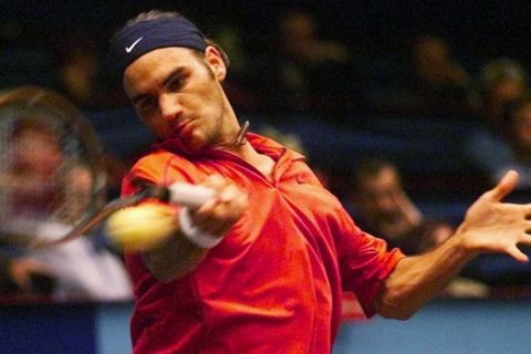 Roger Federer from Switzerland returns the ball to Sweden's Magnus Norman during their first round match of the ATP tennis tournament in Vienna, Tuesday, Oct. 10, 2000. (AP Photo/Rudi Blaha)