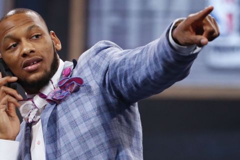 NBA draft prospect Adreian Payne of Michigan State, points to fans before the start of  the 2014 NBA draft, Thursday, June 26, 2014, in New York. (AP Photo/Jason DeCrow) 