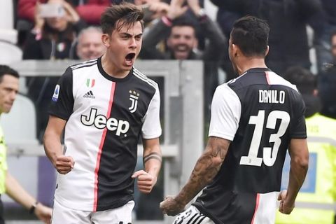 Juventus' Paulo Dybala, left, celebrates scoring his side's opening goal during the Serie A soccer match between Juventus and Brescia, a the Allianz Stadium in Turin, Italy, Sunday, Feb. 16, 2020. (Marco Alpozzi/Lapresse via AP)