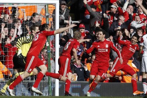 Liverpool's Dirk Kuyt (C) celebrates his first goal against Manchester United with his team mates during their English Premier League soccer match at Anfield in Liverpool, northern England, March 6, 2011.   REUTERS/Phil Noble   (BRITAIN - Tags: SPORT SOCCER) NO ONLINE/INTERNET USAGE WITHOUT A LICENCE FROM THE FOOTBALL DATA CO LTD. FOR LICENCE ENQUIRIES PLEASE TELEPHONE ++44 (0) 207 864 9000