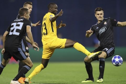 Young Boys' Moumi Ngamaleu, center, duels for the ball with Dinamo Zagreb's Amer Gojak, right, during the Champions League qualifying play-off second leg soccer match between Dinamo Zagreb and Young Boys in Zagreb, Croatia, Tuesday, Aug. 28, 2018. (AP Photo)
