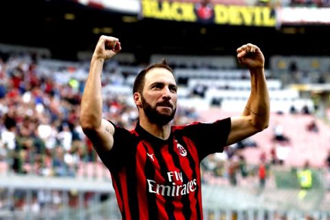 AC Milan's Gonzalo Higuain celebrates after scoring his side's opening goal during the Serie A soccer match between AC Milan and Chievo Verona at the San Siro Stadium, in Milan, Italy, Sunday, Oct. 7, 2018. (AP Photo/Antonio Calanni)