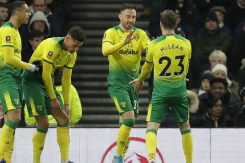 Norwich City's Josip Drmic, second from right, celebrates with his teammate Kenny McLean after scoring his side's first goal, during the English FA Cup fifth round soccer match between Tottenham Hotspur and Norwich City at Tottenham Hotspur stadium in London Wednesday, March 4, 2020. (AP Photo/Kirsty Wigglesworth)