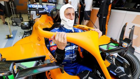 Daniel Ricciardo, McLaren enters his cockpit in the team's garage
