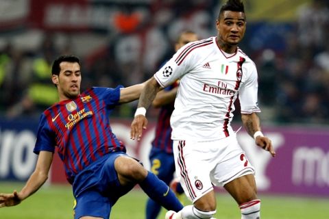 AC Milan midfielder Kevin Prince Boateng, right, of Ghana, is tackled by Barcelona midfielder Sergio Busquets during a Champions League first leg quarterfinals soccer match between AC Milan and Barcelona at the San Siro stadium in Milan, Italy, Wednesday, March 28, 2012. (AP Photo/Antonio Calanni)