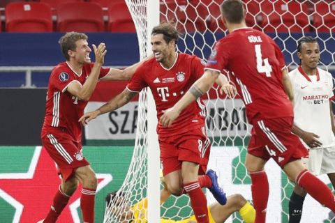 Bayern's Javi Martinez, second from left, celebrates after scoring his side's second goal during the UEFA Super Cup soccer match between Bayern Munich and Sevilla at the Puskas Arena in Budapest, Hungary, Thursday, Sept. 24, 2020. (AP Photo/Laszlo Balogh, Pool)