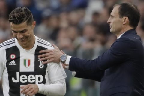 Juventus coach Massimiliano Allegri , right, talks Cristiano Ronaldo during a Serie A soccer match between Juventus and AC Fiorentina, at the Allianz stadium in Turin, Italy, Saturday, April 20, 2019. Juventus needs a draw against visiting Fiorentina to clinch a record-extending eighth straight Serie A title. (AP Photo/Luca Bruno)