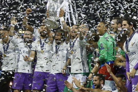 Real Madrid's Marcelo raises the trophy after the Champions League final soccer match between Juventus and Real Madrid at the Millennium stadium in Cardiff, Wales Saturday June 3, 2017. (AP Photo/Kirsty Wigglesworth)