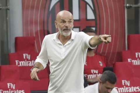 AC Milan's manager Stefano Pioli gives instructions to his players during a Serie A soccer match between AC Milan and Parma, at the San Siro stadium in Milan, Italy, Wednesday, July 15, 2020. (AP Photo/Luca Bruno)