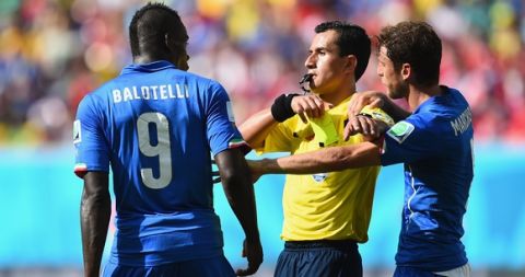 RECIFE, BRAZIL - JUNE 20:  Referee Enrique Osses gives Mario Balotelli of Italy a yellow card during the 2014 FIFA World Cup Brazil Group D match between Italy and Costa Rica at Arena Pernambuco on June 20, 2014 in Recife, Brazil.  (Photo by Jamie McDonald/Getty Images)