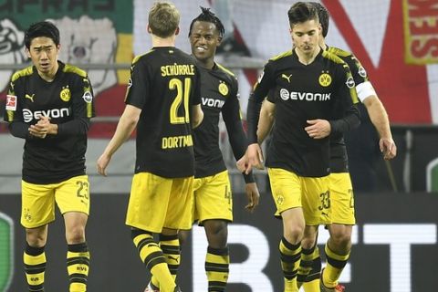 Dortmund's new forward Michy Batshuayi blinks to Dortmund's Andre Schuerrle after scoring the opening goal during the German Bundesliga soccer match between 1. FC Cologne and Borussia Dortmund in Cologne, Germany, Friday, Feb. 2, 2018. (AP Photo/Martin Meissner)