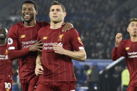 Liverpool's Georginio Wijnaldum, left, and Liverpool's James Milner celebrate during the English Premier League soccer match between Wolverhampton Wanderers and Manchester City at the Molineux Stadium in Wolverhampton, England, Friday, Dec. 27, 2019. (AP Photo/Rui Vieira)