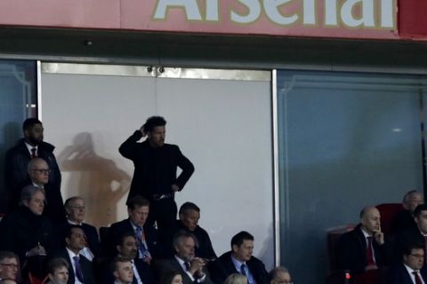 Altetico's head coach Diego Simeone watches his players from the stands during the Europa League semifinal first leg soccer match between Arsenal FC and Atletico Madrid at Emirates Stadium in London, Thursday, April 26, 2018. (AP Photo/Matt Dunham)