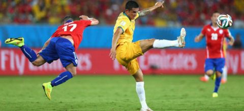CUIABA, BRAZIL - JUNE 13:  Gary Medel of Chile falls after colliding with Tim Cahill of Australia during the 2014 FIFA World Cup Brazil Group B match between Chile and Australia at Arena Pantanal on June 13, 2014 in Cuiaba, Brazil.  (Photo by Clive Brunskill/Getty Images)
