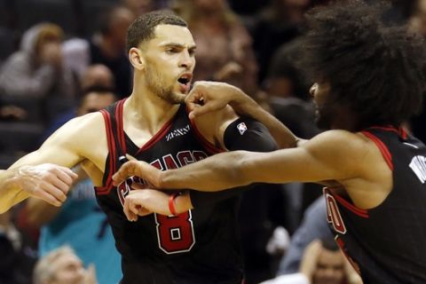 Chicago Bulls' Zach LaVine (8) celebrates his winning three-point basket with teammate Coby White (0) during the second half of an NBA basketball game i against the Charlotte Hornets in Charlotte, N.C., Saturday, Nov. 23, 2019. (AP Photo/Bob Leverone)
