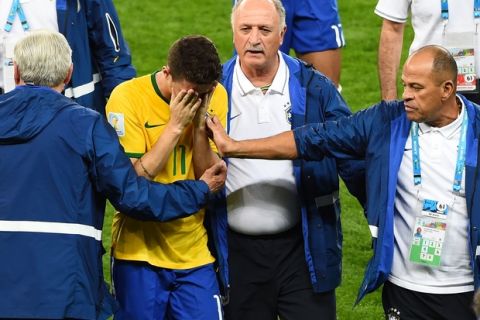 BELO HORIZONTE, BRAZIL - JULY 08:  Head coach Luiz Felipe Scolari of Brazil and staff console Oscar after a 7-1 defeat to Germany during the 2014 FIFA World Cup Brazil Semi Final match between Brazil and Germany at Estadio Mineirao on July 8, 2014 in Belo Horizonte, Brazil.  (Photo by Jamie McDonald/Getty Images)
