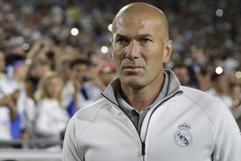 Real Madrid manager Zinedine Zidane walks across the field before the team's International Champions Cup soccer match against the Manchester City Wednesday, July 26, 2017, in Los Angeles. (AP Photo/Jae C. Hong)