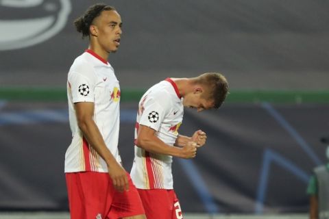 Leipzig's Dani Olmo, right, celebrates after scoring his side's first goal during the Champions League quarterfinal match between RB Leipzig and Atletico Madrid at the Jose Alvalade stadium in Lisbon, Portugal, Thursday, Aug. 13, 2020. (Miguel A. Lopes/Pool Photo via AP)