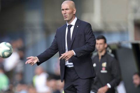Real Madrid's head coach Zinedine Zidane stands on the touchline during La Liga soccer match between Celta and Real Madrid at the Balaídos Stadium in Vigo, Spain, Saturday, Aug. 17, 2019. (AP Photo/Luis Vieira)