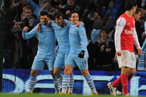 Manchester City's Spanish midfielder David Silva (2nd L) celebrates with Argentinian striker Sergio Aguero (L) and French midfielder Samir Nasri after scoring the opening goal of the English Premier League football match between Manchester City and Arsenal at Etihad Stadium in Manchester, north-west England on December 18, 2011. AFP PHOTO/ANDREW YATES

RESTRICTED TO EDITORIAL USE. No use with unauthorized audio, video, data, fixture lists, club/league logos or live services. Online in-match use limited to 45 images, no video emulation. No use in betting, games or single club/league/player publications. (Photo credit should read ANDREW YATES/AFP/Getty Images)