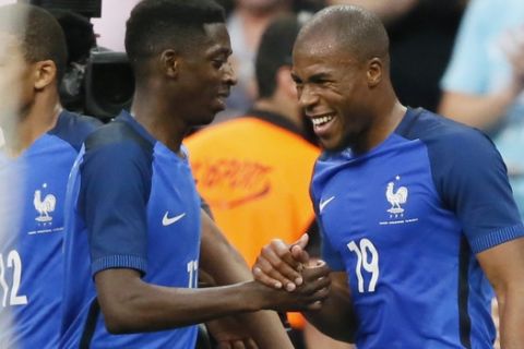 France's Djibril Sidibe,right, celebrates his side's 2nd goal during a friendly soccer match between France and England at the Stade de France in Saint Denis, north of Paris, France, Tuesday, June 13, 2017. (AP Photo/Francois Mori)