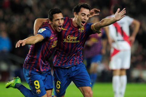 Barcelona's Chilean forward Alexis Sanchez (L) celebrates with teammate Barcelona's midfielder Xavi Hernandez (R) after scoring during the Spanish league football match FC Barcelona vs Rayo Vallecano on November 29, 2011 at the Camp Nou stadium in Barcelona.   AFP PHOTO/ JOSEP LAGO (Photo credit should read JOSEP LAGO/AFP/Getty Images)