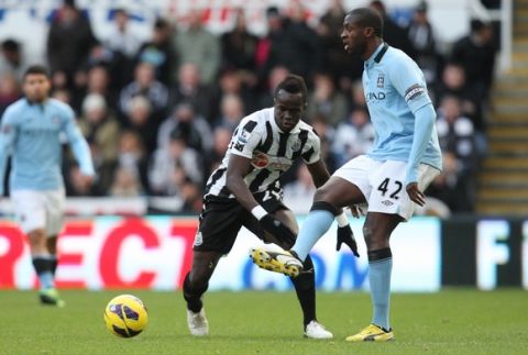 Manchester City's captain Yaya Toure, right, vies for the ball with Newcastle United's Cheick Tiote, during their English Premier League soccer match at St James' Park, Newcastle, England, Saturday, Dec. 15, 2012. (AP Photo/Scott Heppell)