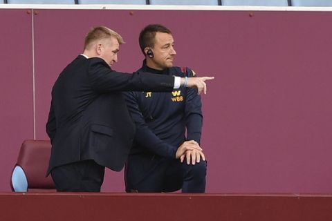 Aston Villa's head coach Dean Smith, left and assistant coach John Terry on stands during the English Premier League soccer match between Aston Villa and Chelsea at the Villa Park stadium in Birmingham, England, Sunday, June 21, 2020. (Justin Tallis/Pool via AP)