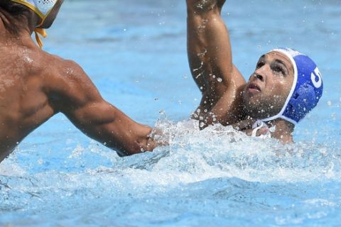 Aleksa Ukropina, left, of Montenegro challenges for the ball with Ioannis Fountoulis of Greece during the men's water polo Montenegro vs. Greece quarterfinal match Swimming World Championships in Hajos Alfred National Swimming Pool in Budapest, Hungary, Tuesday, July 25, 2017. (Balazs Czagany/MTI via AP)