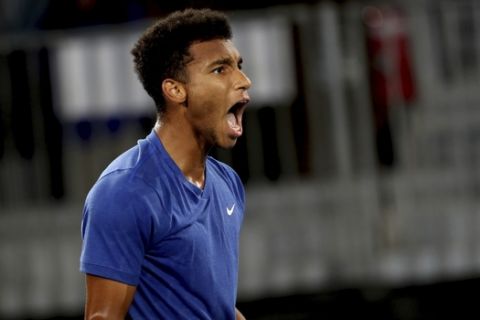 Canada's Felix Auger-Aliassime celebrates winning the second set against Russia's Andrey Rublev during their Adelaide International tennis match in Adelaide, Australia, Friday, Jan. 17, 2020. (AP Photo/James Elsby)