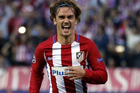 Atletico's Antoine Griezmann, left, celebrates after scoring a penalty during a Champions League semifinal, 2nd leg soccer match between Atletico de Madrid and Real Madrid, in Madrid, Spain, Wednesday, May 10, 2017 . (AP Photo/Daniel Ochoa de Olza)