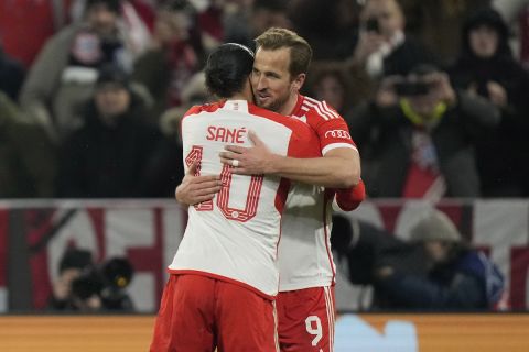 Bayern's Harry Kane, right, celebrates with his teammate Leroy Sane after scoring his side's third goal during the Champions League round of 16 second leg soccer match between FC Bayern Munich and Lazio at the Allianz Arena stadium in Munich, Germany, Tuesday, March 5, 2024. (AP Photo/Matthias Schrader)