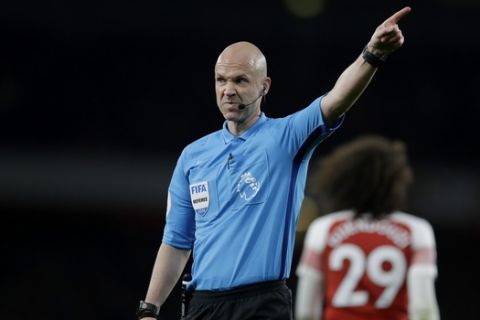 Referee Anthony Taylor points during the English Premier League soccer match between Arsenal and Newcastle United at Emirates stadium in London, Monday, April 1, 2019. (AP Photo/Kirsty Wigglesworth)