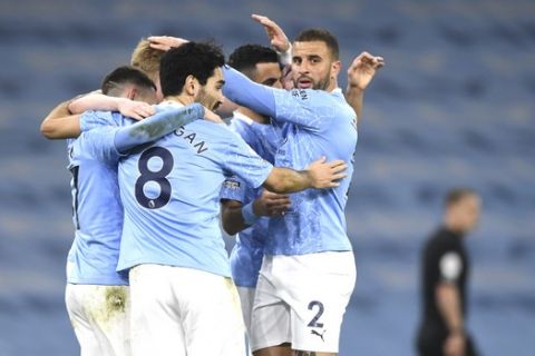 Manchester City players celebrate after Manchester City's Kevin De Bruyne scored his side's fifth goal during the English Premier League soccer match between Manchester City and Southampton at the Etihad Stadium in Manchester, England, Wednesday, March 10, 2021. (Gareth Copley/Pool via AP)