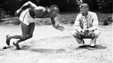 Sprinter Jesse Owens is shown practicing his starts in this undated photo. The man at right is unidentified. Date and location are unknown. (AP Photo)
