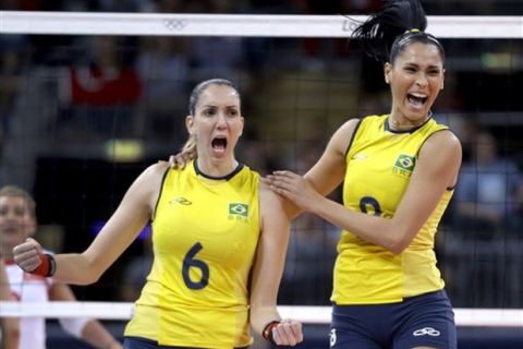 Brazil's Thaisa Menezes, left, and teammate Jaqueline Carvalho celebrate a point for their team during a women's preliminary volleyball match against Turkey at the 2012 Summer Olympics, Saturday, July 28, 2012, in London. (AP Photo/Jeff Roberson)
