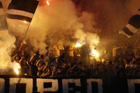 Partizan soccer fans light torches during a Serbian National soccer league derby match between Red Star and Partizan, in Belgrade, Serbia, Saturday, April 16, 2016. The game ended in a 1-1 draw. (AP Photo/Darko Vojinovic)