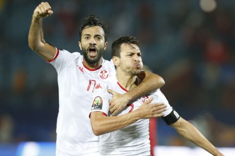 Tunisia's Youssef Msakni, right and Tunisia's Taha Khenissi celebrate after scoring during the African Cup of Nations quarterfinal soccer match between Madagascar and Tunisia in Al Salam stadium in Cairo, Egypt, Thursday, July 11, 2019. (AP Photo/Ariel Schalit)