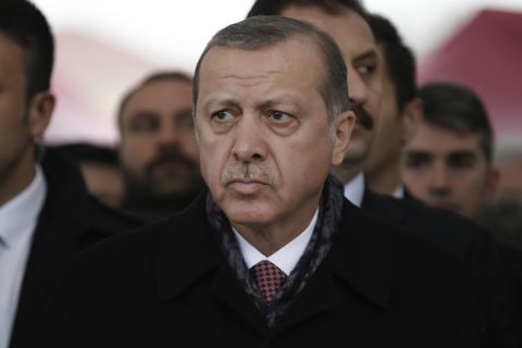 Turkey's President Recep Tayyip Erdogan attends the funeral prayers for police officer Hasim Usta, who was killed with dozens of others late Saturday outside the Besiktas football club stadium Vodafone Arena, in Istanbul, Monday, Dec. 12, 2016. Turkey's police rounded up more than 100 members of a Kurdish political party on Monday as the country mourned the dozens killed in a bombing attack near an Istanbul soccer stadium. Turkish authorities have banned distribution of images relating to the Istanbul explosions within Turkey. (AP Photo/Emrah Gurel)