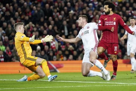 Liverpool's Mohamed Salah, front right, scores his side's opening goal during the English Premier League soccer match between Liverpool and Sheffield United at Anfield Stadium, Liverpool, England, Thursday, Jan. 2, 2020. (AP Photo/Jon Super)